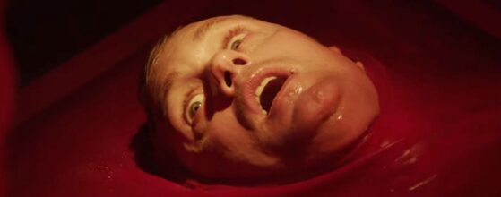 Alexander Skarsgård en una alberca de sangre en la pelicula muerte infinita